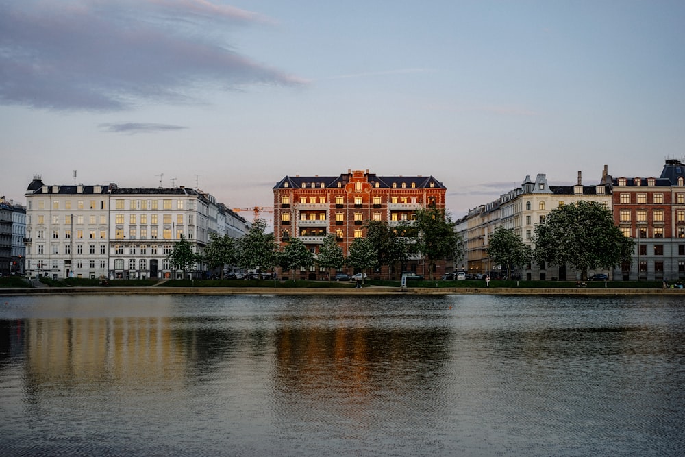 brown and white concrete building near body of water during daytime