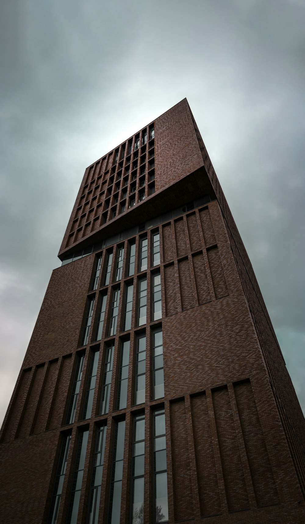 brown concrete building under cloudy sky during daytime