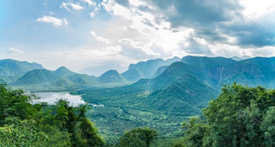 green mountains under white clouds during daytime in Kodaikanal India