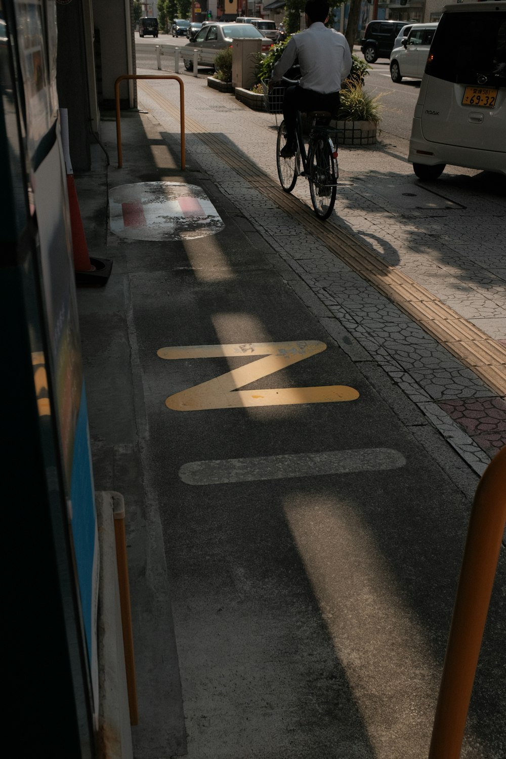 man in black jacket riding bicycle on road during daytime