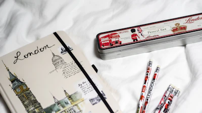 Close-up of a notebook with English notes and a British flag pen.