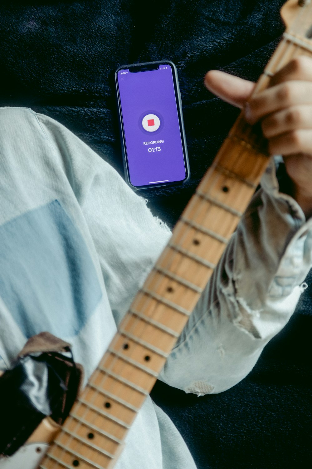 person holding brown electric guitar