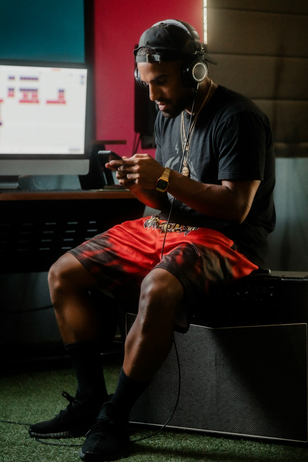 man in blue crew neck t-shirt and red shorts sitting on black chair