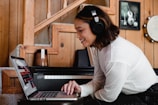 woman in gray long sleeve shirt using macbook pro