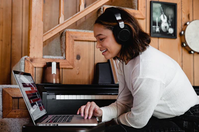 A user happily listening to live radio on their laptop in a cozy living room.