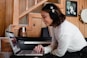woman in gray long sleeve shirt using macbook pro