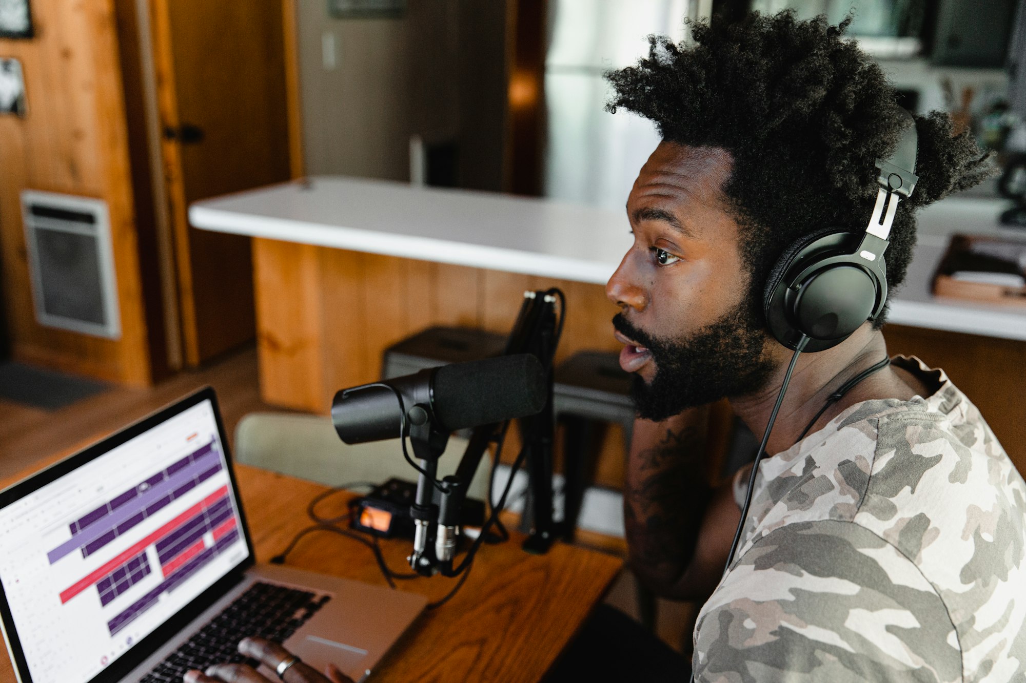 Image of person podcasting with a mic and podcast editing software