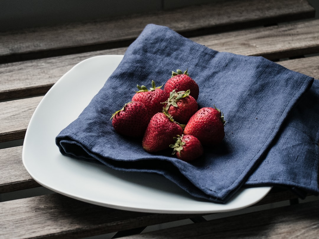 red strawberries on blue textile