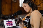 woman in brown sweater wearing headphones