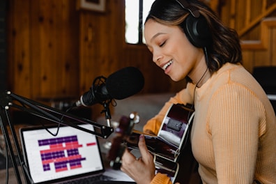 woman in brown sweater wearing headphones