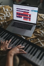 person using macbook air on brown and white textile