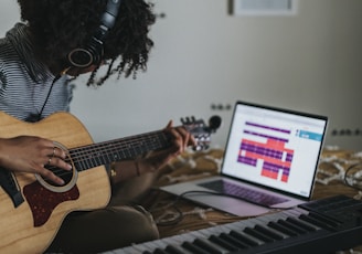 woman playing brown acoustic guitar