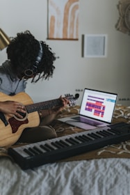 woman playing brown acoustic guitar