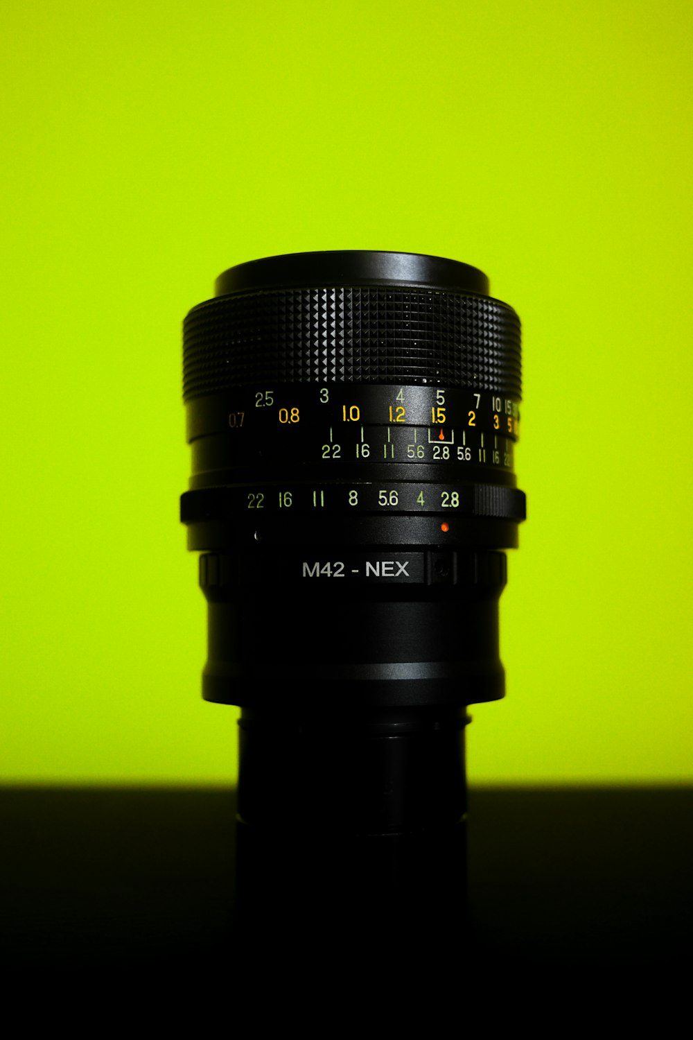 black camera lens on yellow surface