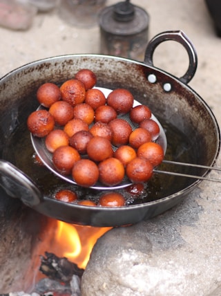 red round fruits in black cooking pan