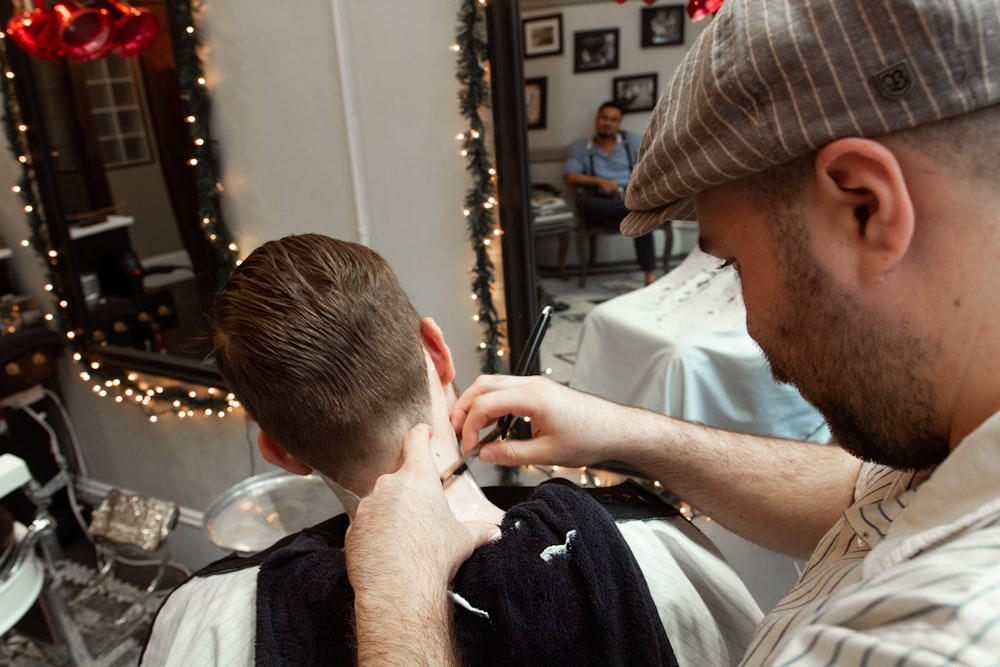 a man getting his hair cut in a barber shop