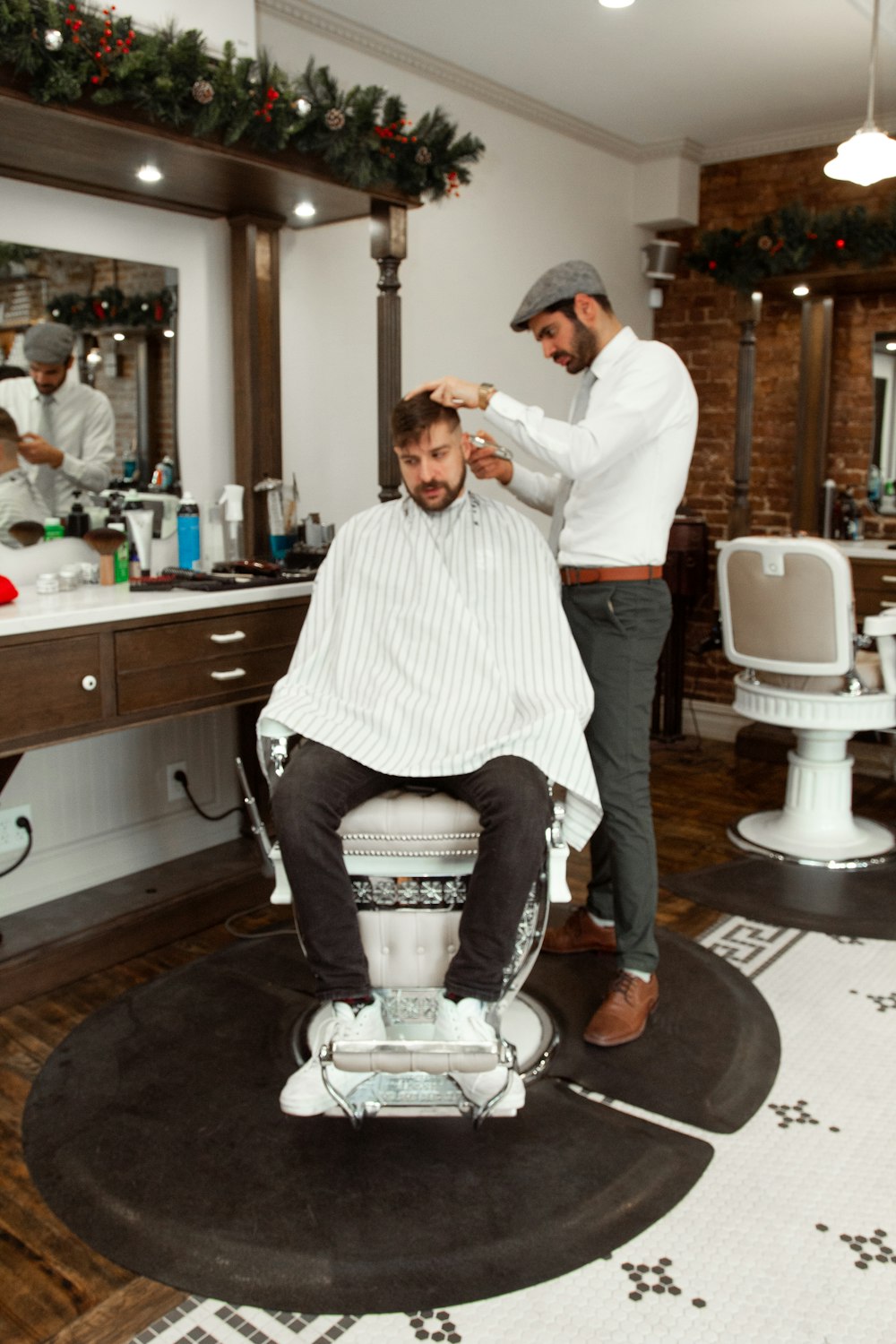 man in white dress shirt sitting on barber chair