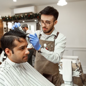 man in white dress shirt cutting hair of man in white dress shirt