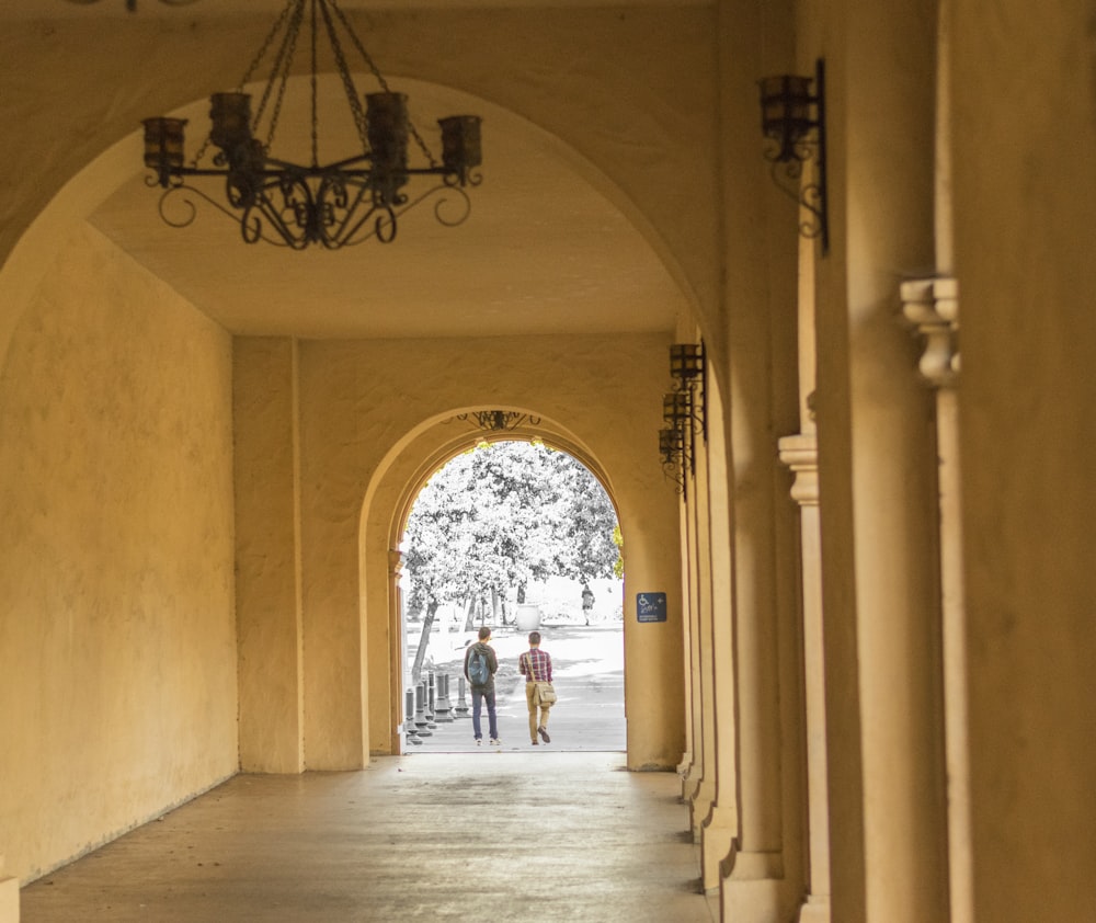 woman in white dress walking on hallway