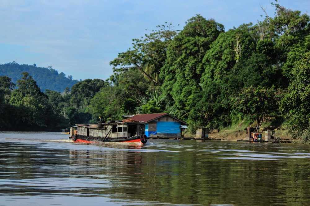 brown wooden house on lake during daytime