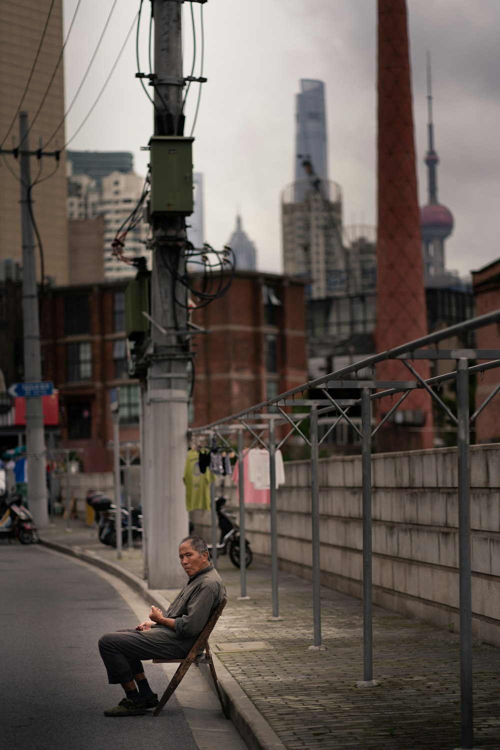 man in black jacket and black pants walking on sidewalk during daytime