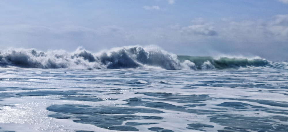 ocean waves under blue sky during daytime