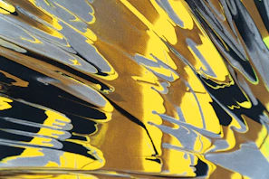 Dynamic streaks of green and black paint layered on rough paper.