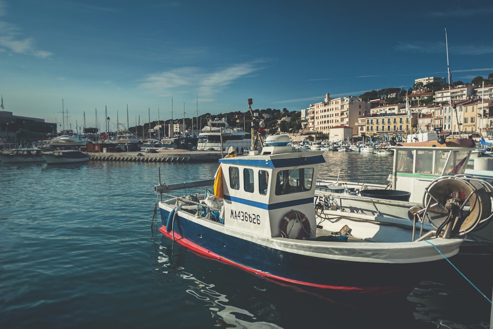 white and red boat on water during daytime