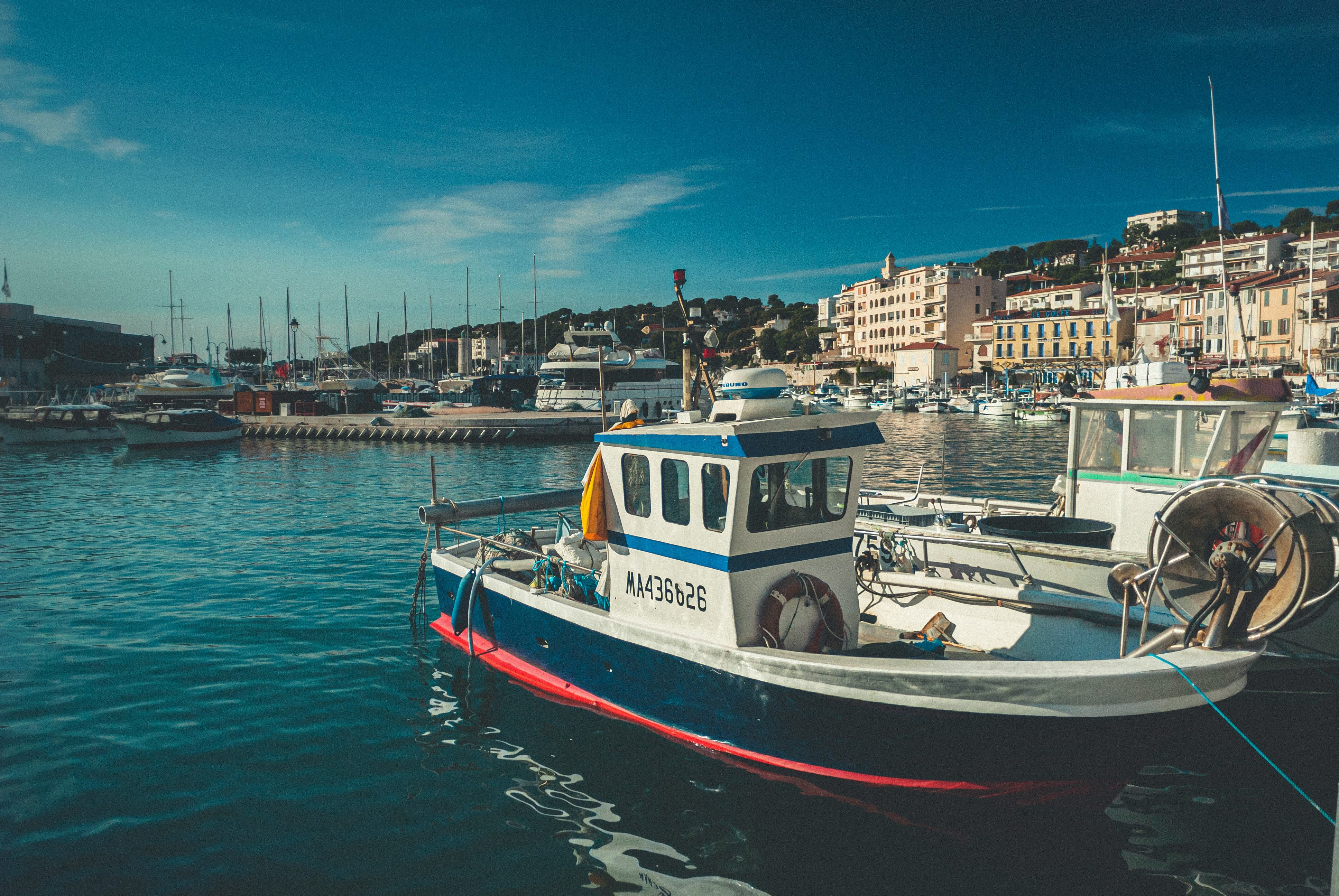 white and red boat on water during daytime