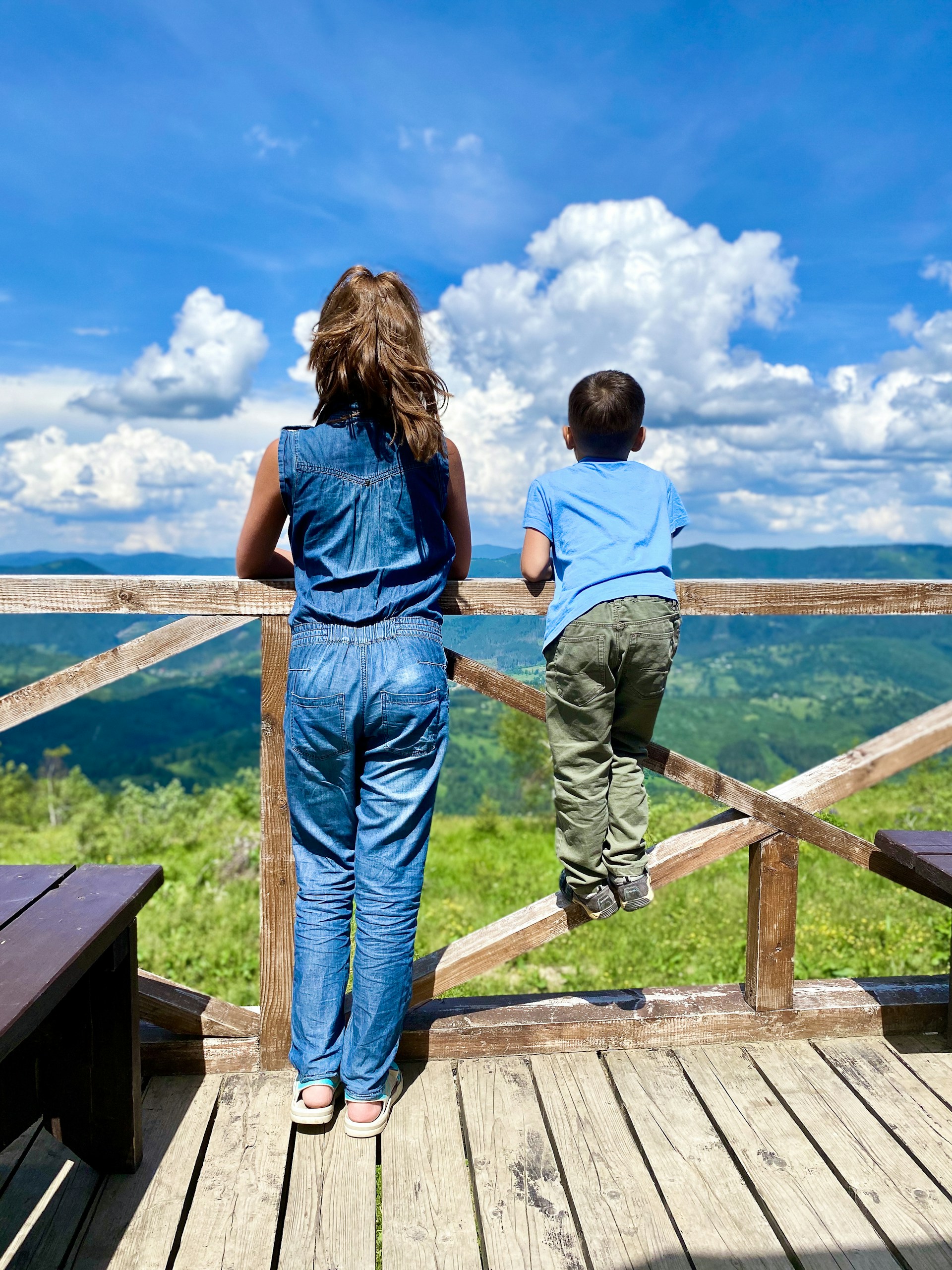 woman wearing yellow long-sleeved dress under white clouds and blue sky during daytime