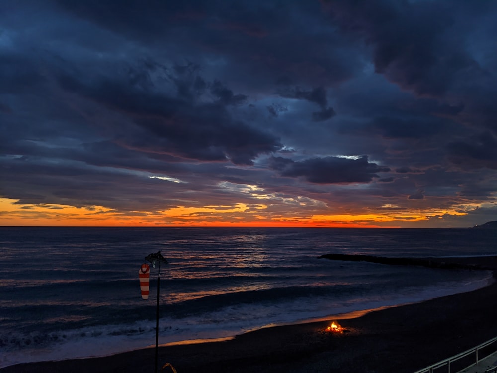 person standing on beach during sunset