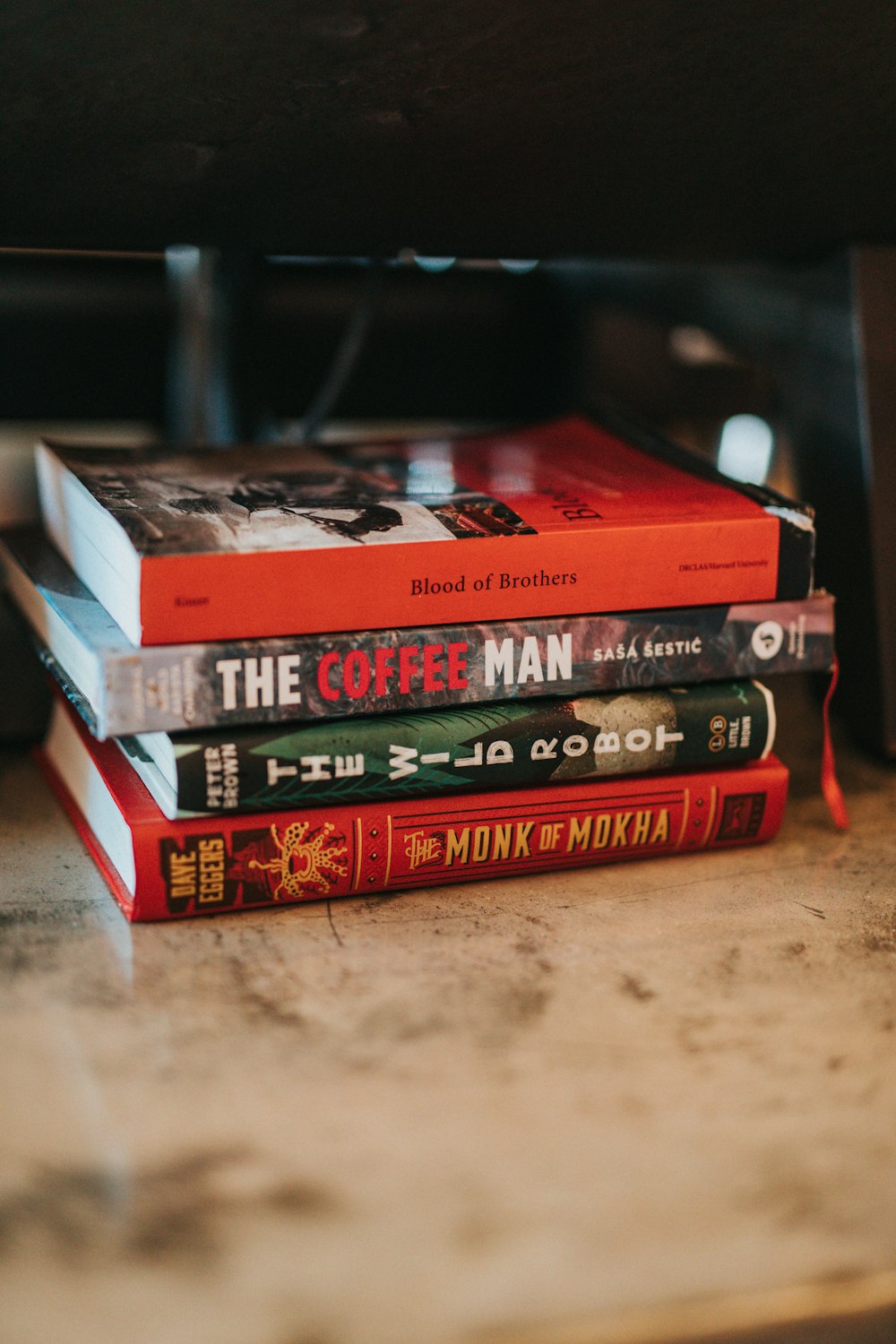 red and black books on brown wooden table