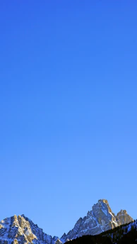 A breathtaking close-up of jagged ice peaks shimmering under a clear blue sky.