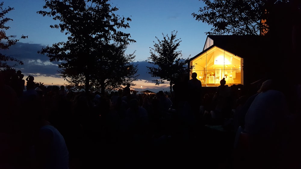 silhouette of people sitting on bench during night time