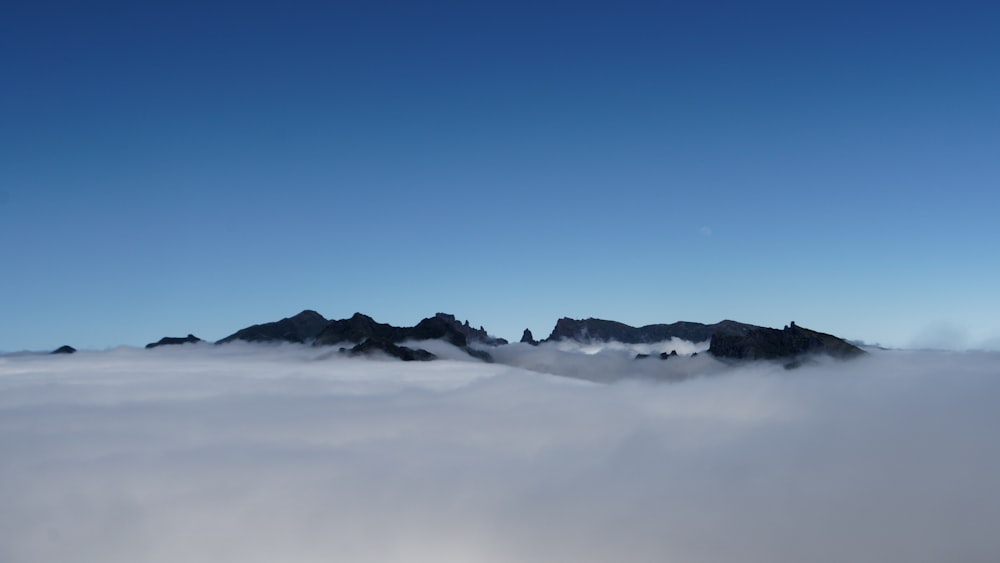 snow covered mountain under blue sky during daytime