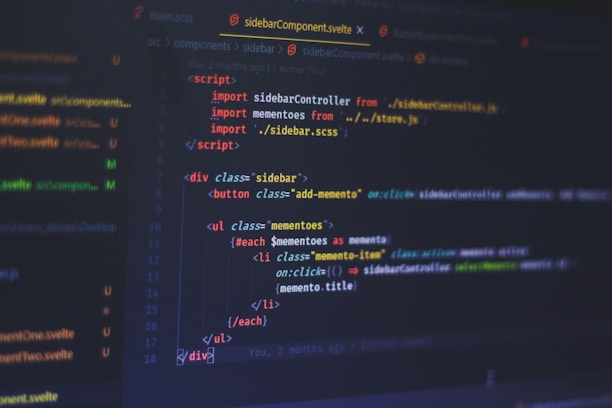 A computer screen displays code written in a text editor. The code is related to web development and includes HTML and JavaScript. The interface shows a dark theme with syntax highlighting, featuring different colors for commands, variables, and elements. Some parts of the screen show filenames and directories on the left.