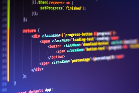 Computer code displayed on a monitor, featuring syntax highlighting. The code appears to be written in JavaScript, with HTML elements indicating a part of a web application. Various tags, class names, and functions are visible, emphasizing a focus on front-end development.