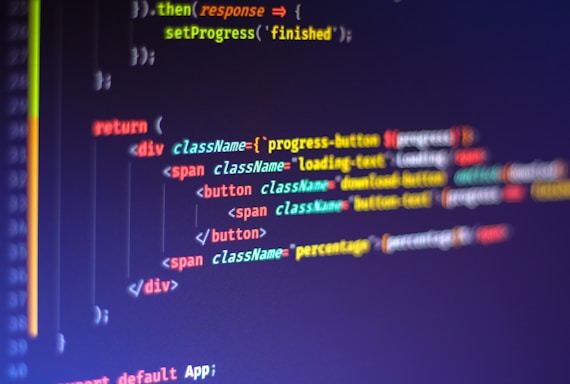 Computer code displayed on a monitor, featuring syntax highlighting. The code appears to be written in JavaScript, with HTML elements indicating a part of a web application. Various tags, class names, and functions are visible, emphasizing a focus on front-end development.