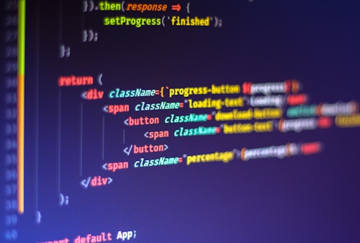 Computer code displayed on a monitor, featuring syntax highlighting. The code appears to be written in JavaScript, with HTML elements indicating a part of a web application. Various tags, class names, and functions are visible, emphasizing a focus on front-end development.