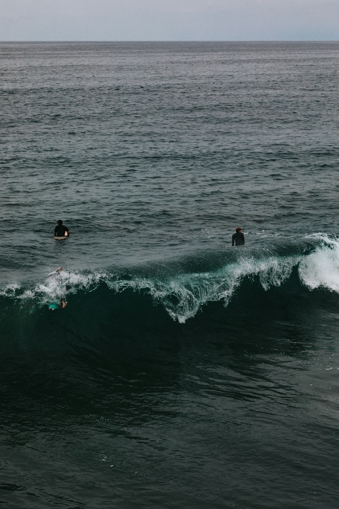 person surfing on sea waves during daytime