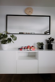 An inspiring image displaying organized sink storage and stylish shoe cabinets.