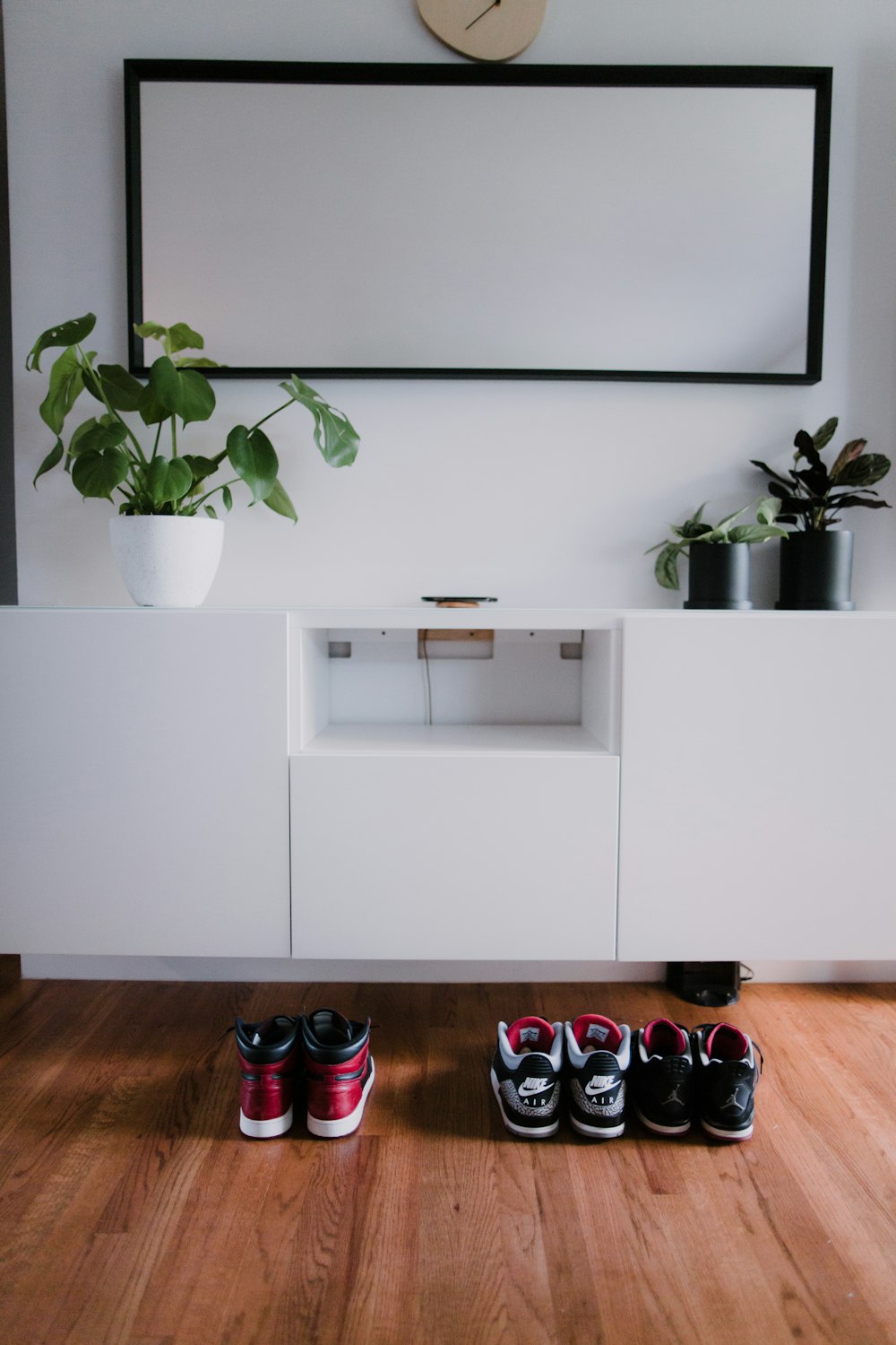 black flat screen tv on white wooden tv rack