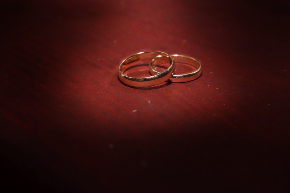 silver ring on brown wooden table