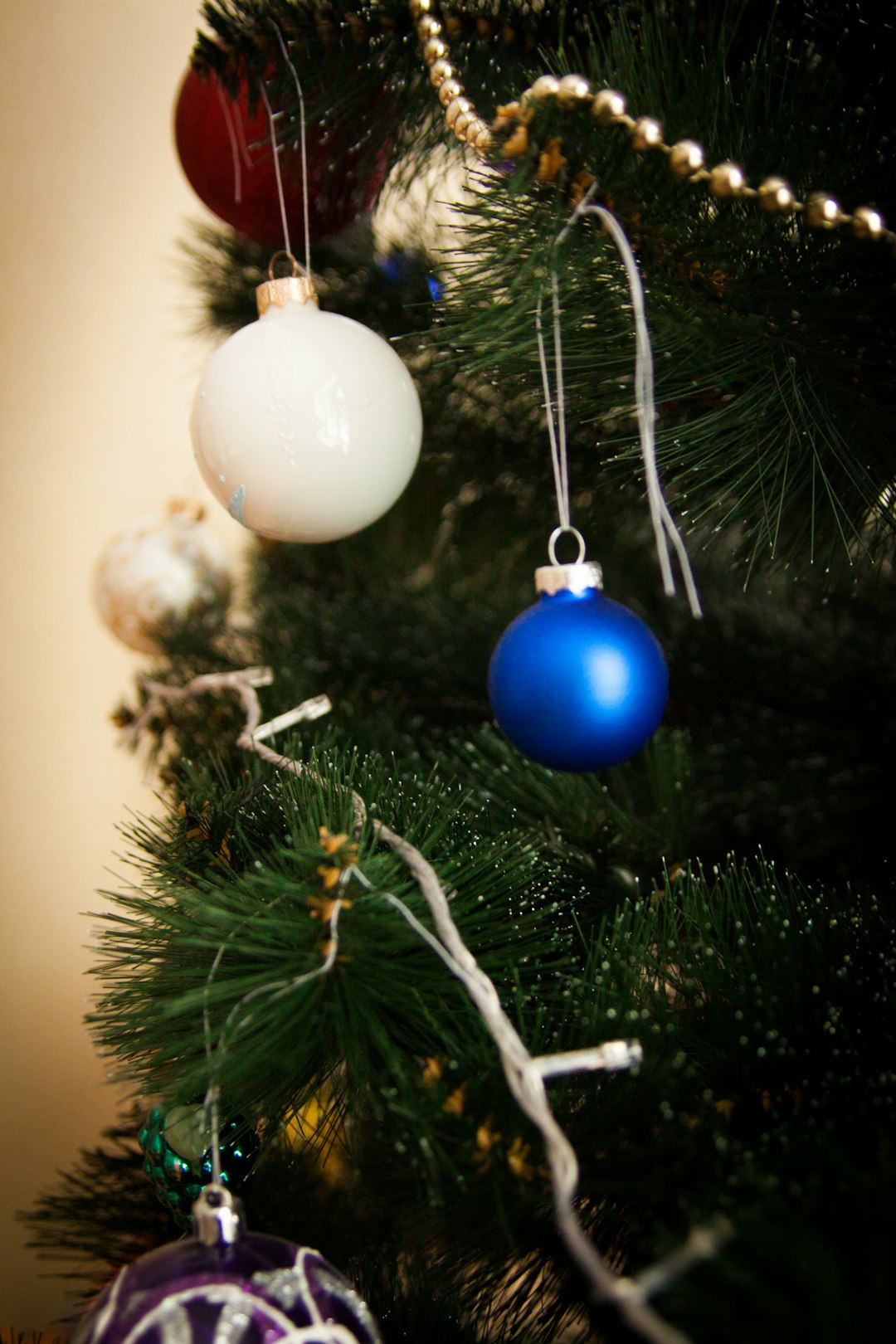 blue and white baubles on green christmas tree