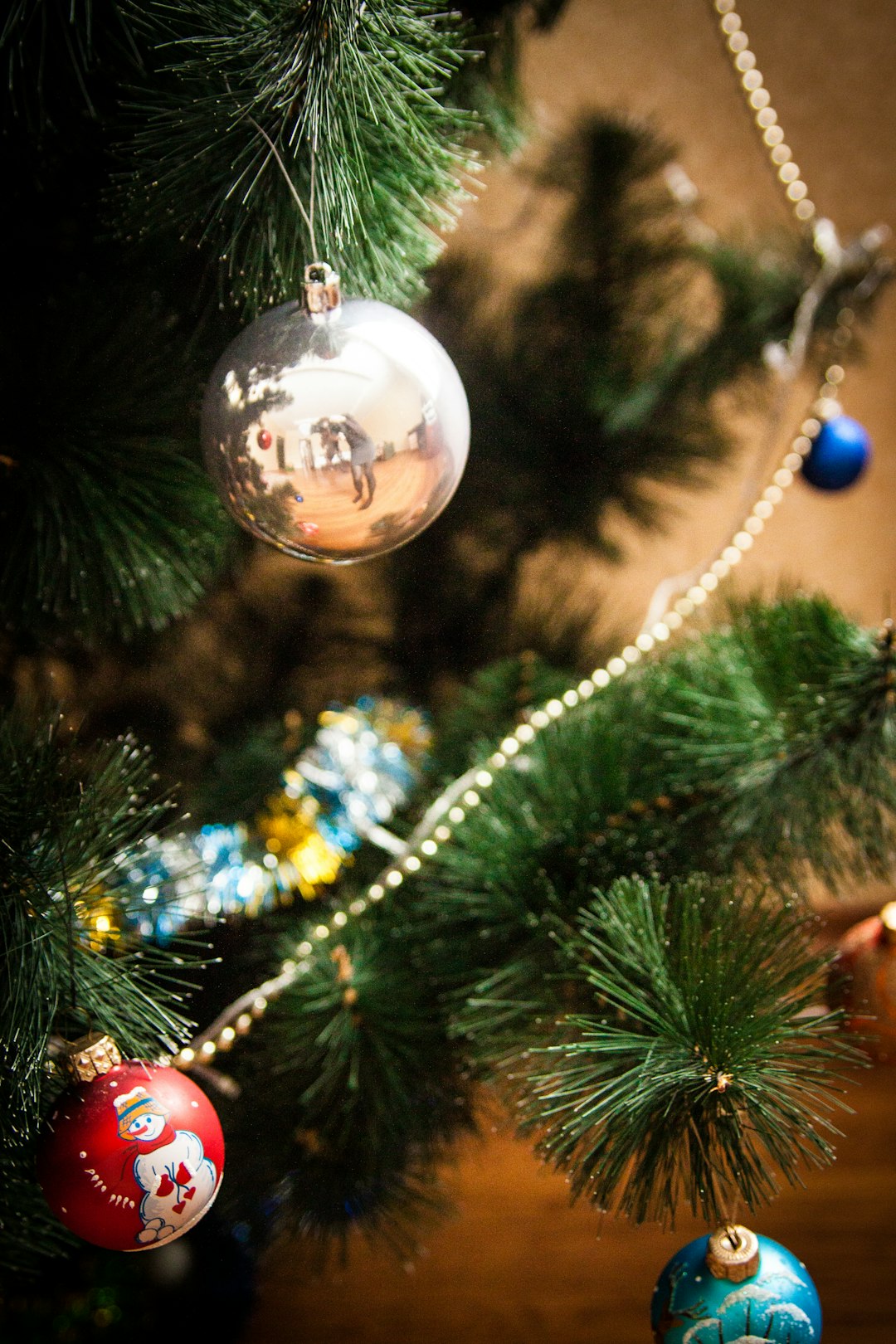 silver bauble on christmas tree