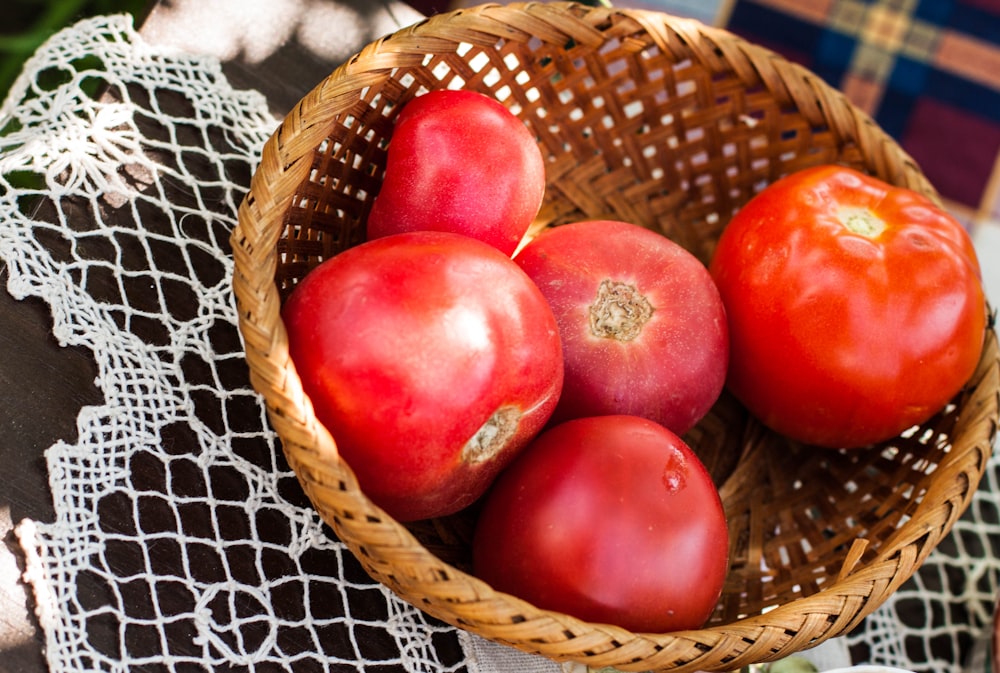 red apples on brown woven basket