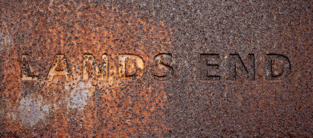 a rusted metal surface with the words lazardds send written on it