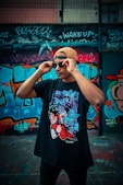 man in black and red floral t-shirt wearing black sunglasses