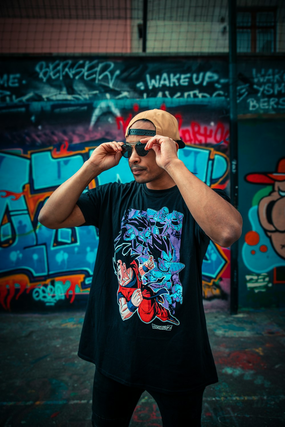 man in black and red floral t-shirt wearing black sunglasses