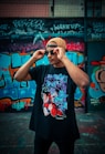 man in black and red floral t-shirt wearing black sunglasses